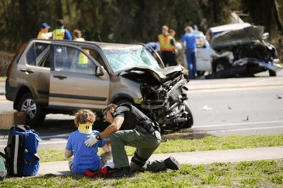 rescue workers help boy injured in auto accident in Gainesville, FL